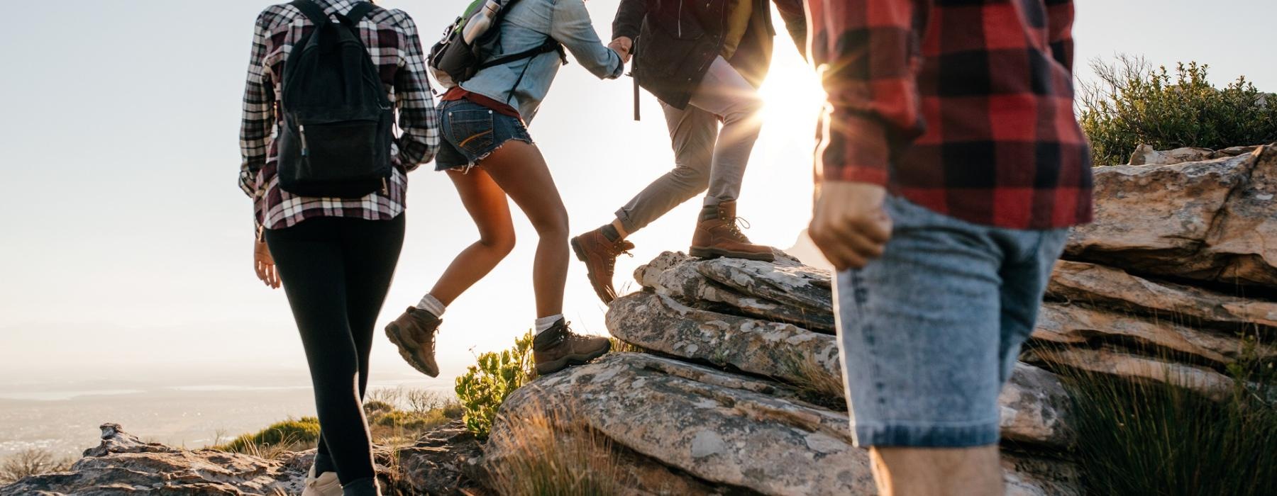a group of people walking on a rock